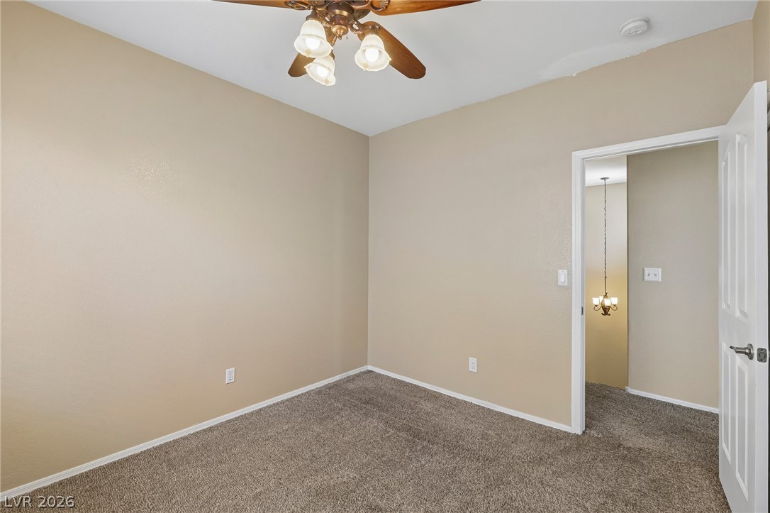 1727 Millstream Way Henderson, NV 89074 - Photo 31 of 46 A well-proportioned interior room with neutral walls and soft carpet, featuring a functional ceiling fan.