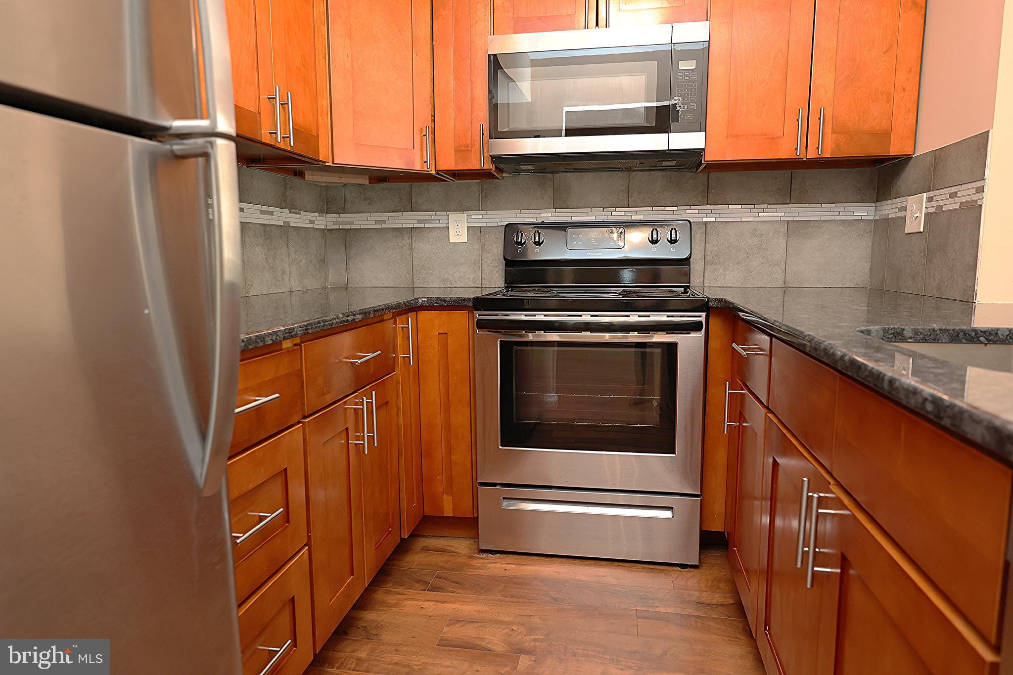13 Five Crown Royal Marlton, NJ 08053 - Photo 11 of 31 a kitchen with stainless steel appliances granite countertop a stove and a microwave