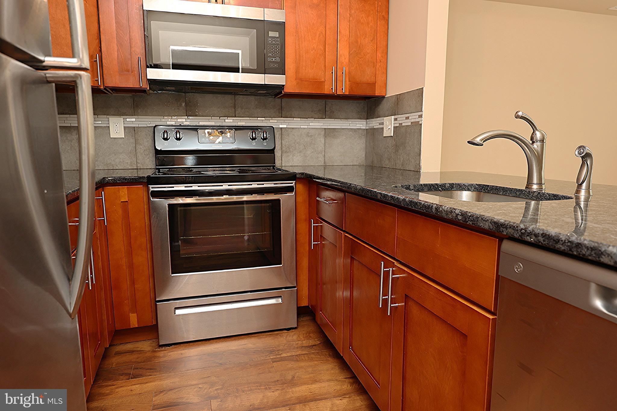 13 Five Crown Royal Marlton, NJ 08053 - Photo 15 of 31 a kitchen with stainless steel appliances granite countertop a stove a microwave and a refrigerator