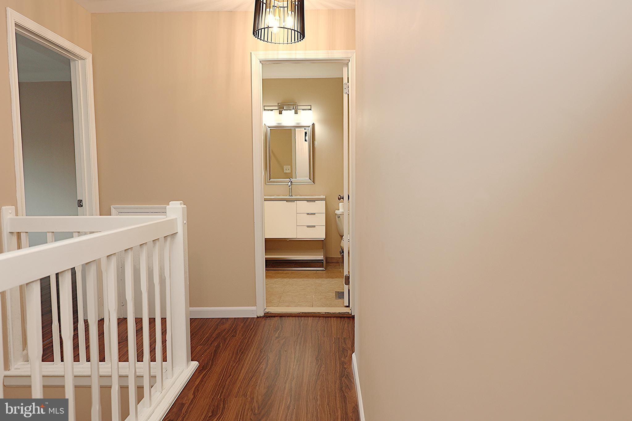 13 Five Crown Royal Marlton, NJ 08053 - Photo 28 of 31 a view of a hallway with wooden floor and a bathroom