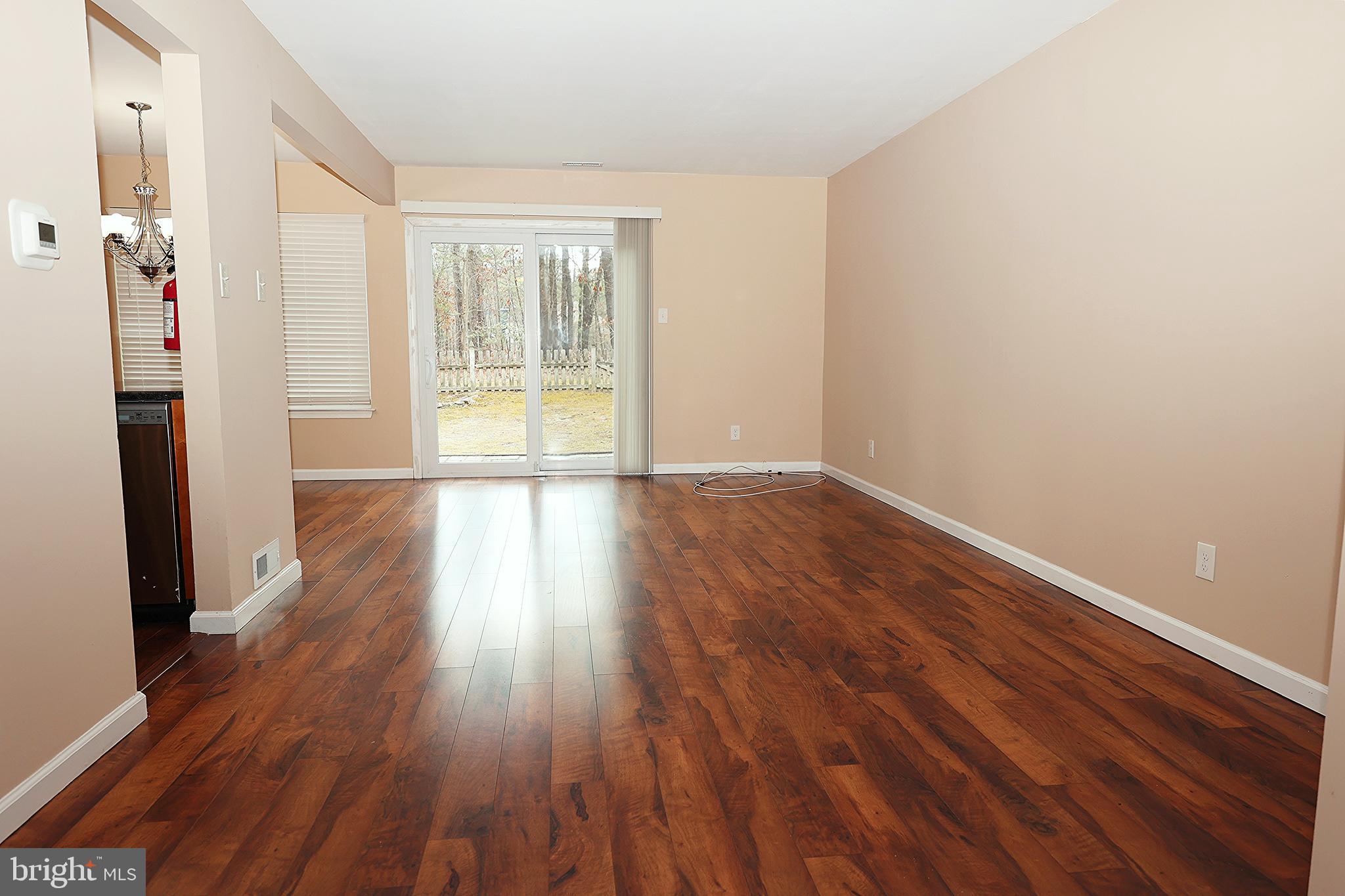 13 Five Crown Royal Marlton, NJ 08053 - Photo 7 of 31 a view of an empty room with wooden floor and a window