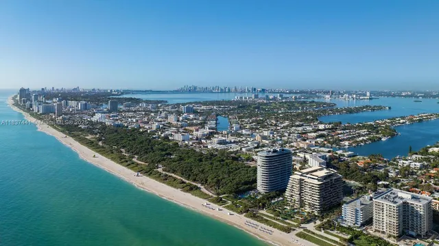 an aerial view of a residential houses with city view