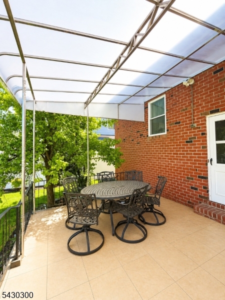 25 Spring Street, Unit A Millburn, NJ 07041 - Photo 18 of 21 a dining room with furniture and a floor to ceiling window