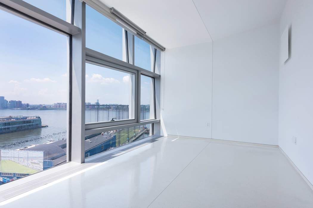 100 11th Avenue, Unit 16C Manhattan, NY 10011 - Photo 12 of 20 a view of a living room hardwood floor and a large window
