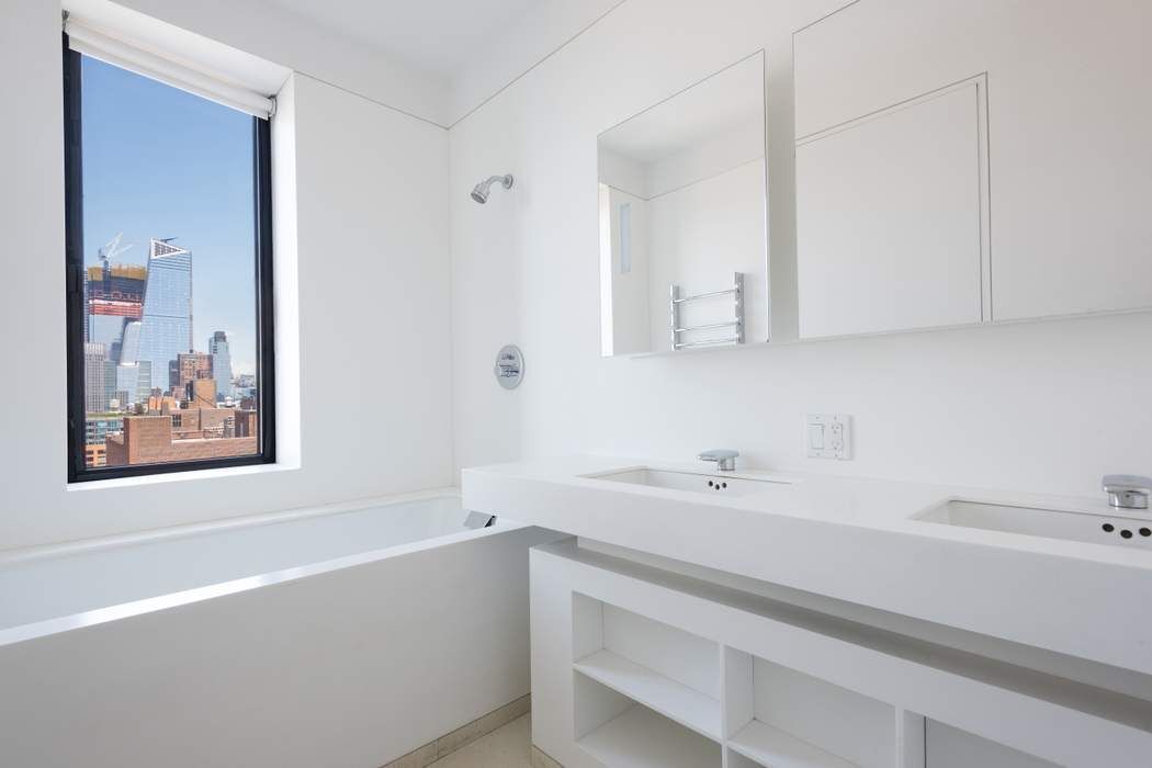 100 11th Avenue, Unit 16C Manhattan, NY 10011 - Photo 13 of 20 a bathroom with a bathtub and a sink