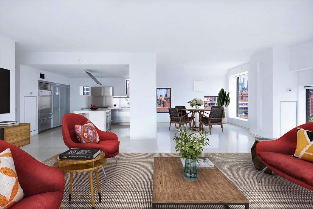 100 11th Avenue, Unit 16C Manhattan, NY 10011 - Photo 3 of 20 a living room with furniture fireplace and view of kitchen