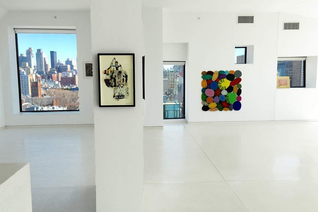 100 11th Avenue, Unit 16C Manhattan, NY 10011 - Photo 9 of 20 a view of a hallway with painting on the wall and a refrigerator