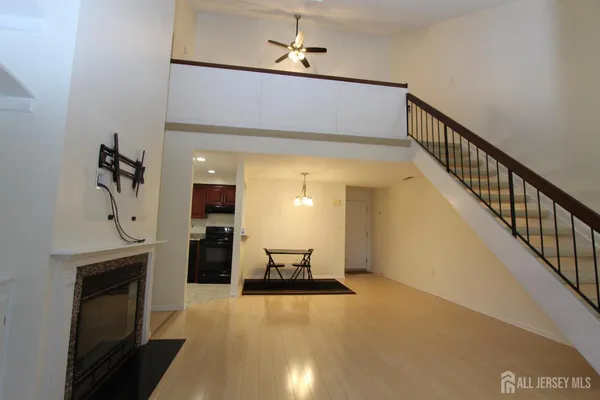 a view of a hallway with a livingroom and furniture