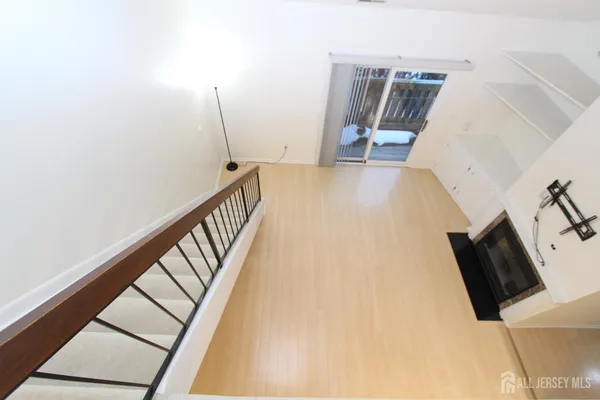 a view of a living room with furniture and wooden floor