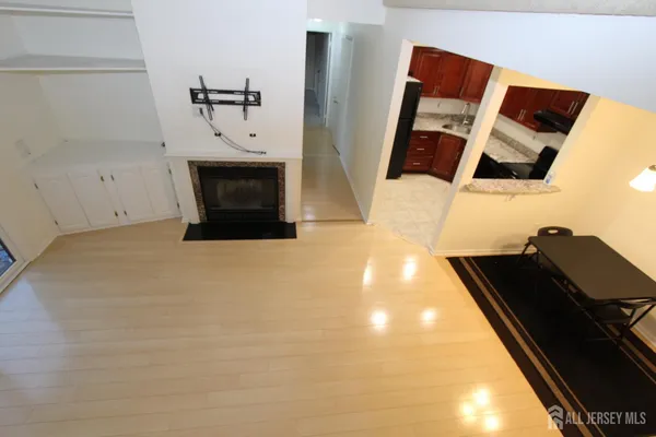 a view of living room with furniture and a fireplace