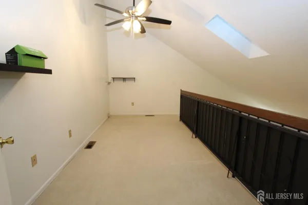 a view of a hallway with a ceiling fan