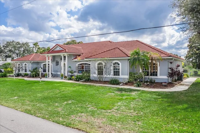a front view of a house with garden and porch