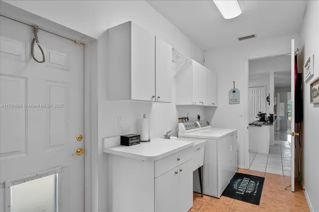 a view of a kitchen with white cabinets and white appliances