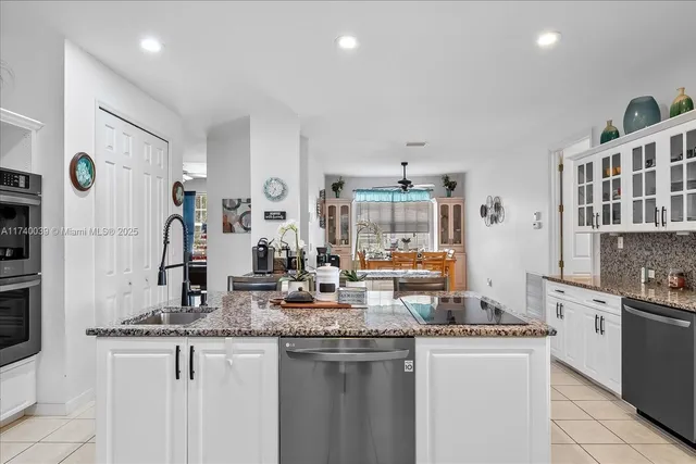 a kitchen with granite countertop a sink and stove