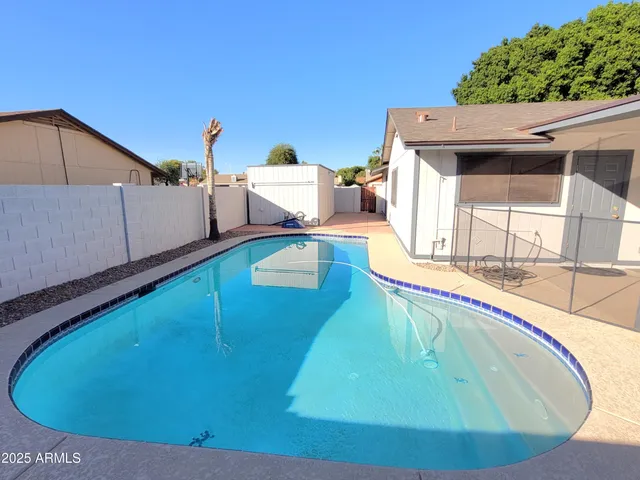 a view of a swimming pool with a lounge chairs