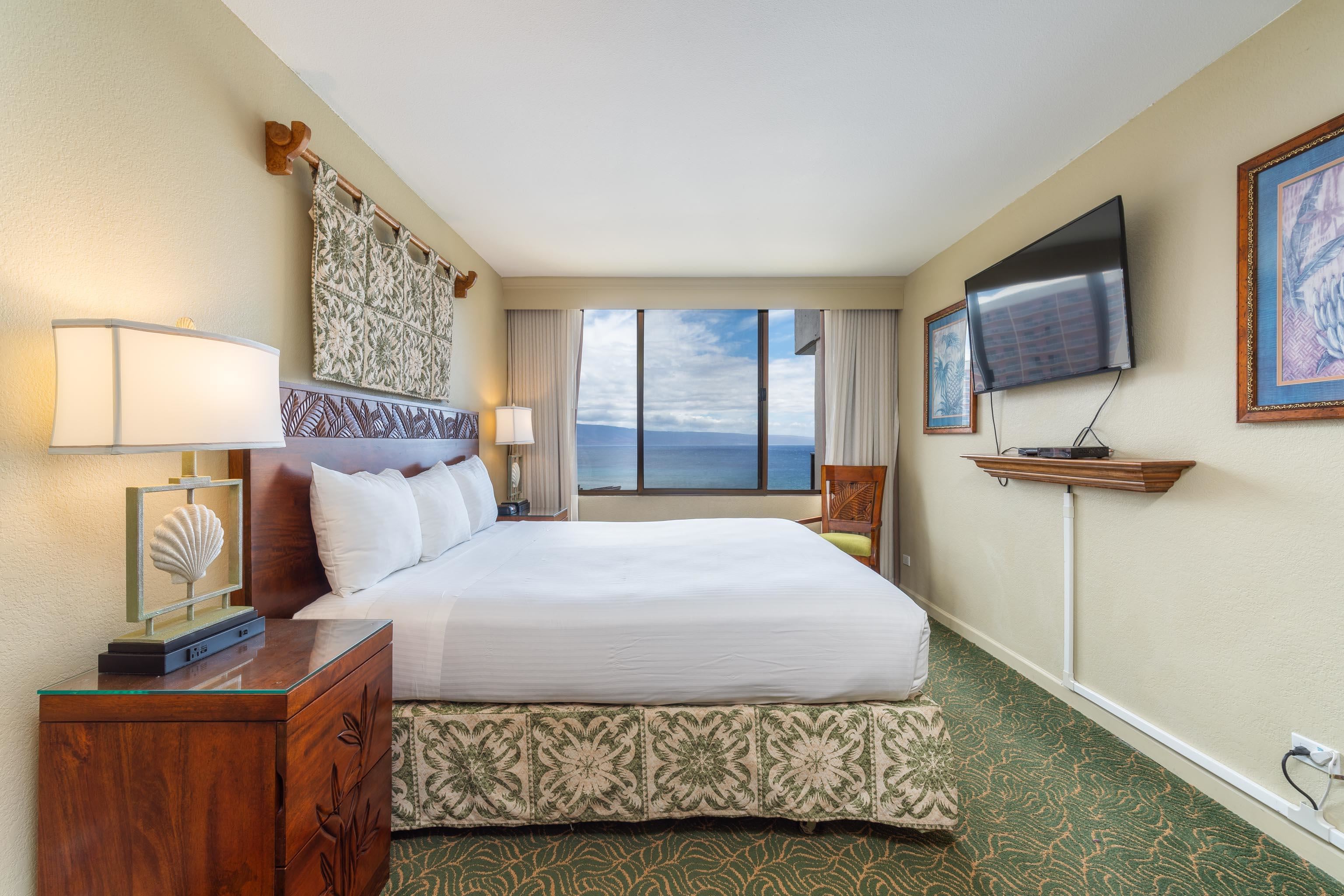 3445 Lower Honoapiilani Road, Unit 905 Lahaina, HI 96761 - Photo 12 of 30 a bedroom with a bed a flat screen tv and window
