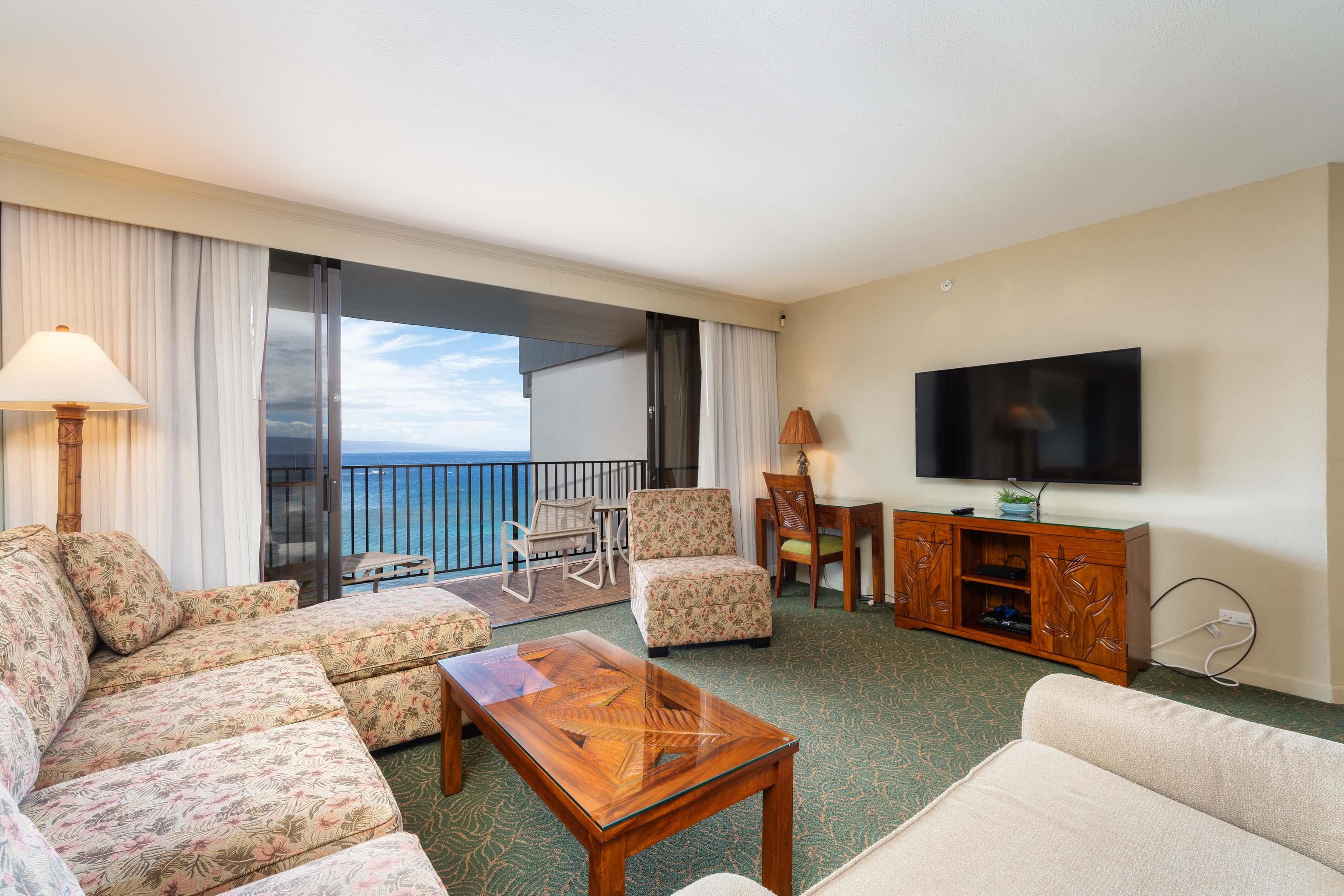 3445 Lower Honoapiilani Road, Unit 905 Lahaina, HI 96761 - Photo 3 of 30 a living room with furniture and a flat screen tv