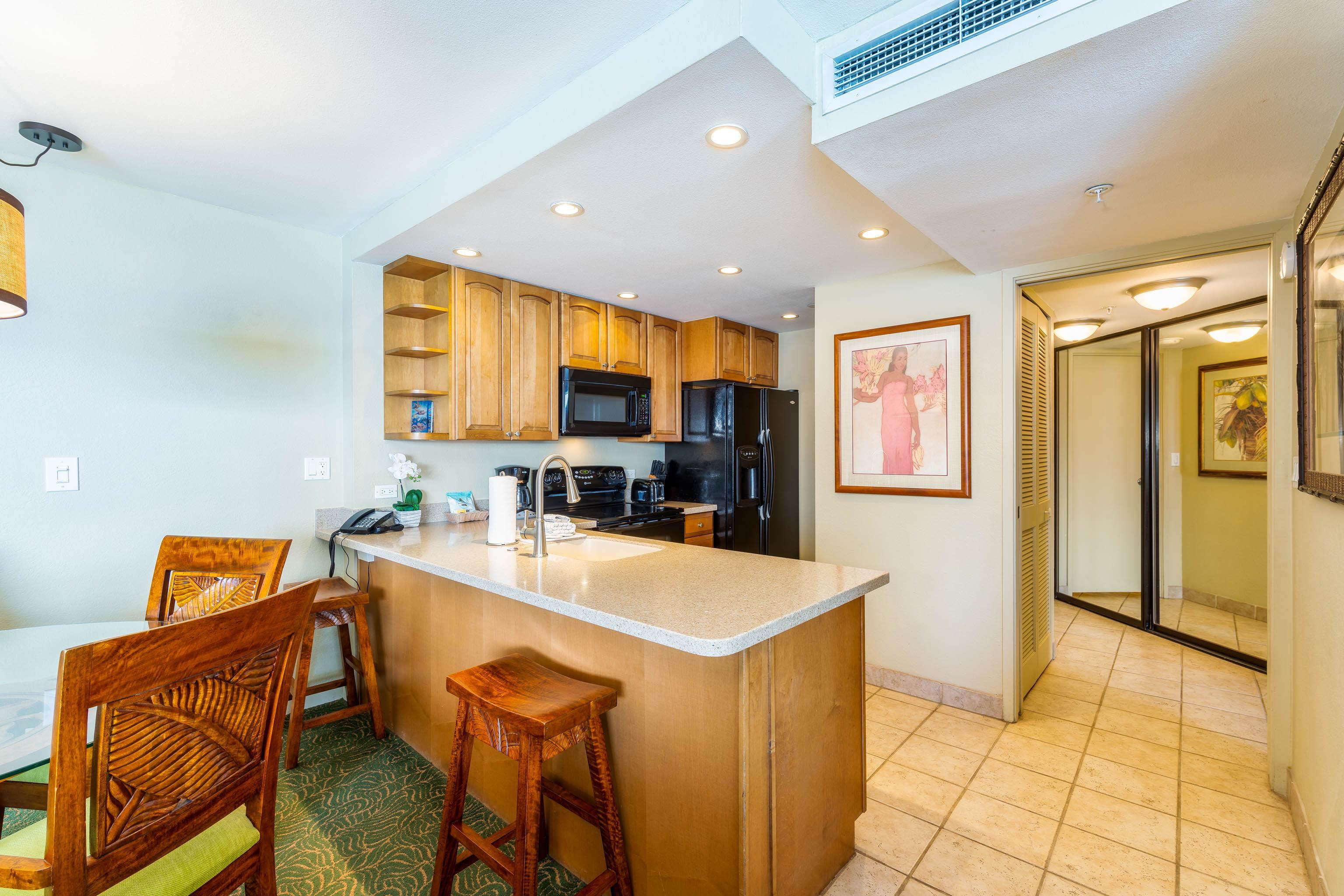 3445 Lower Honoapiilani Road, Unit 905 Lahaina, HI 96761 - Photo 10 of 30 a kitchen with stainless steel appliances kitchen island granite countertop a refrigerator and a stove top oven