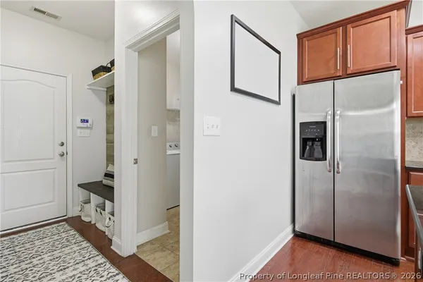 a bathroom with a walk in closet and wooden floor