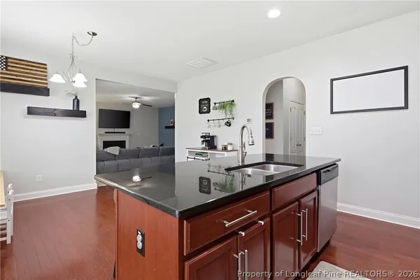 a view of living room with granite countertop furniture and wooden floor