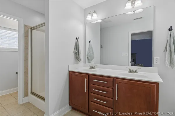 a bathroom with a double vanity sink and a mirror