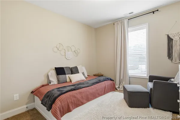 a bedroom with a bed and window