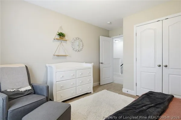 a bedroom with a bed and a chair in it