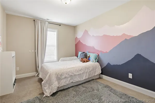 a bedroom with a bed and a potted plant