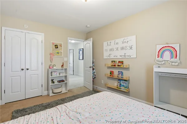 a bedroom with a bed and a couch