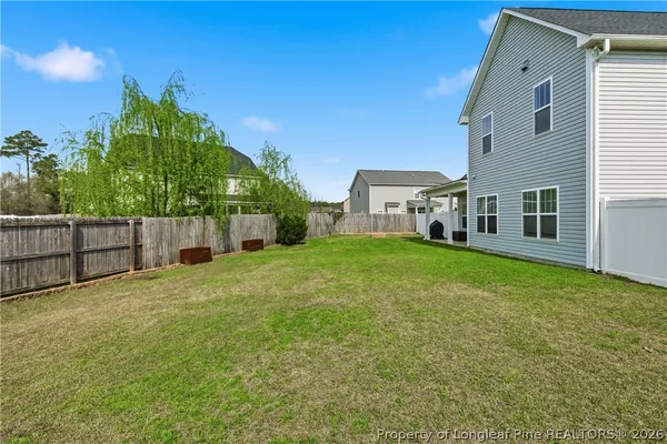 a view of a house with backyard and garden