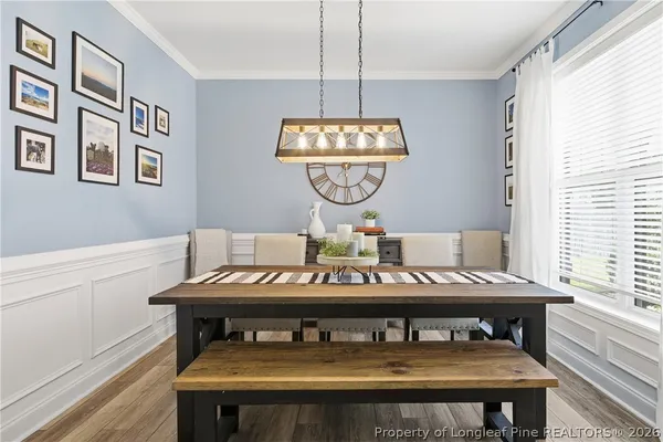 a view of a dining room with furniture window and wooden floor