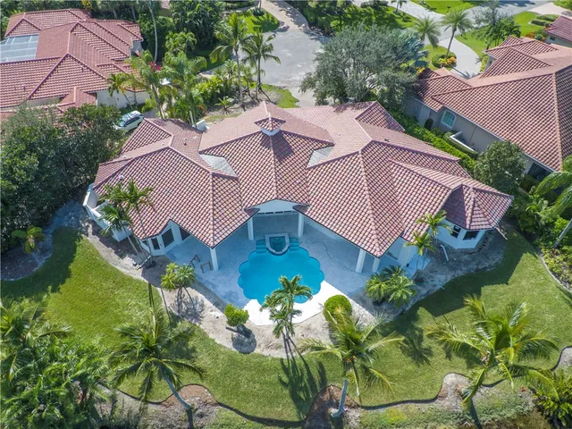 an aerial view of a house with a yard and potted plants