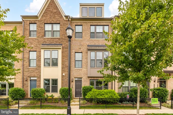 a front view of a residential apartment building with a yard
