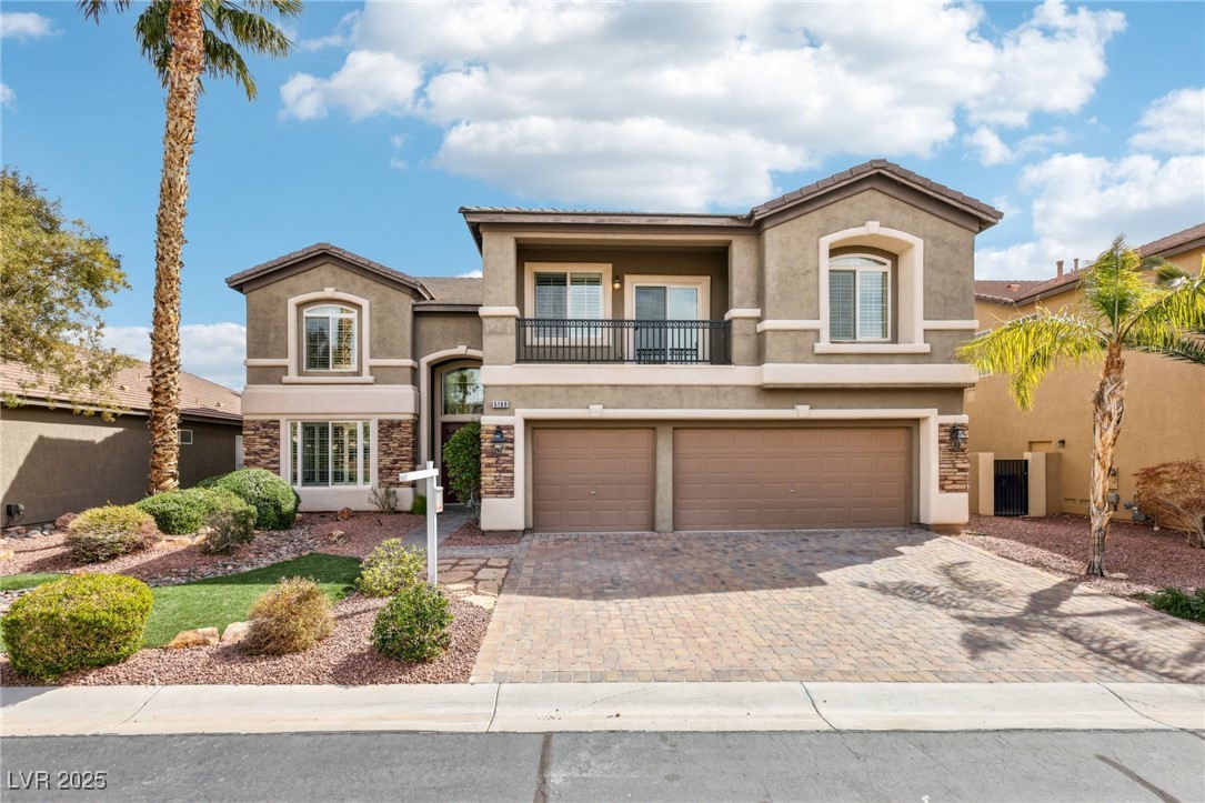 View of front of home featuring a balcony, an atta