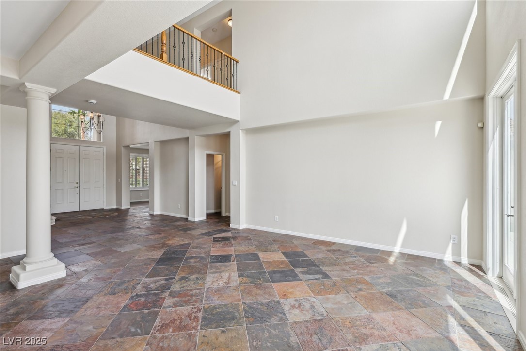 6188 Windfresh Drive Las Vegas, NV 89148 - Photo 11 of 94 Living room with a vaulted ceiling, columns, and s