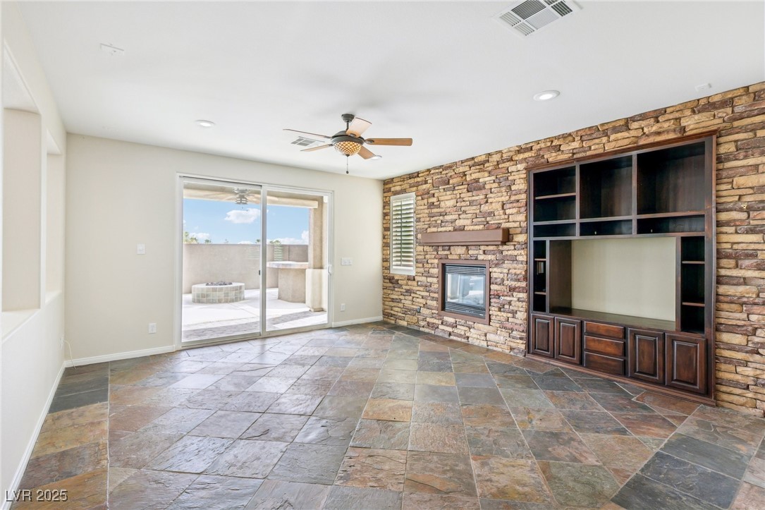 6188 Windfresh Drive Las Vegas, NV 89148 - Photo 15 of 94 Unfurnished living room featuring slate floors, st
