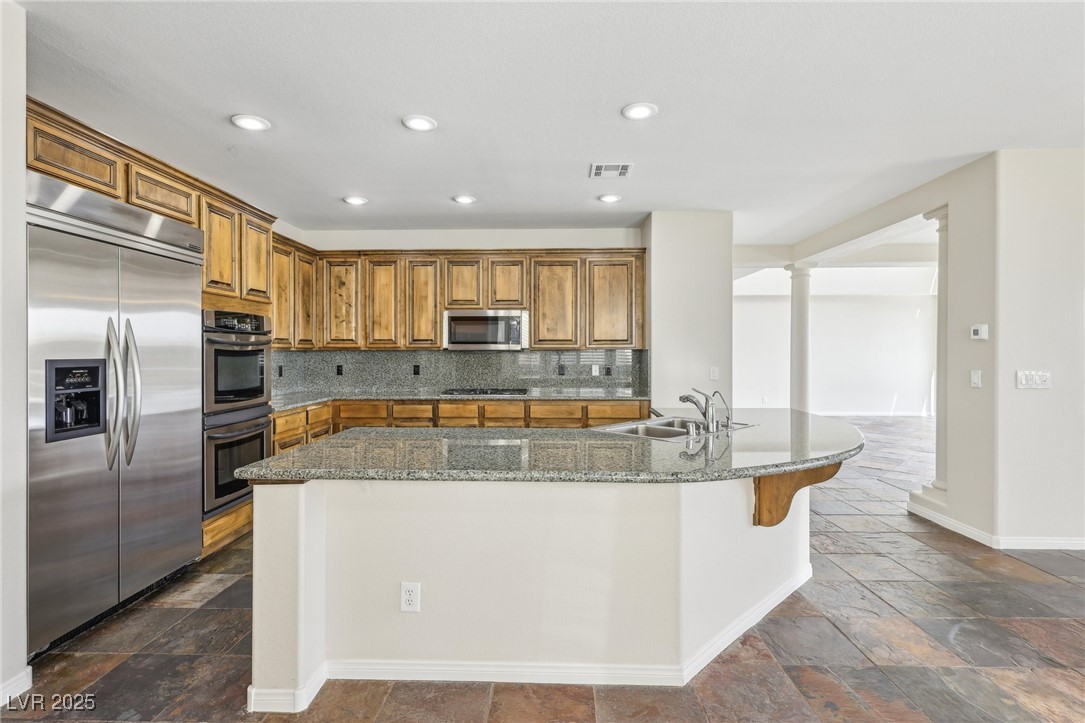 6188 Windfresh Drive Las Vegas, NV 89148 - Photo 21 of 94 Kitchen featuring brown cabinetry, stainless steel