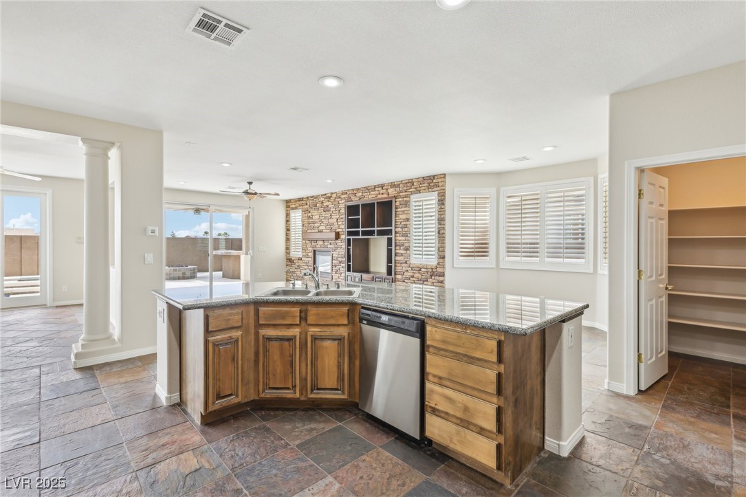 6188 Windfresh Drive Las Vegas, NV 89148 - Photo 25 of 94 Kitchen featuring dishwasher, stone tile floors, a