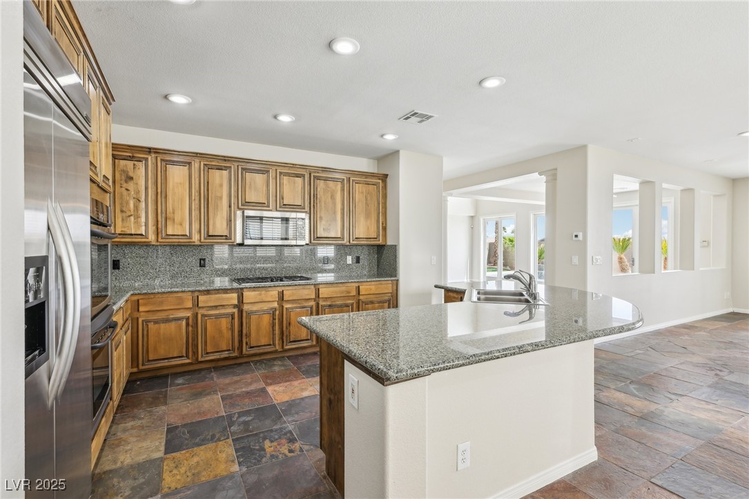6188 Windfresh Drive Las Vegas, NV 89148 - Photo 26 of 94 Kitchen with stone tile floors, appliances with st
