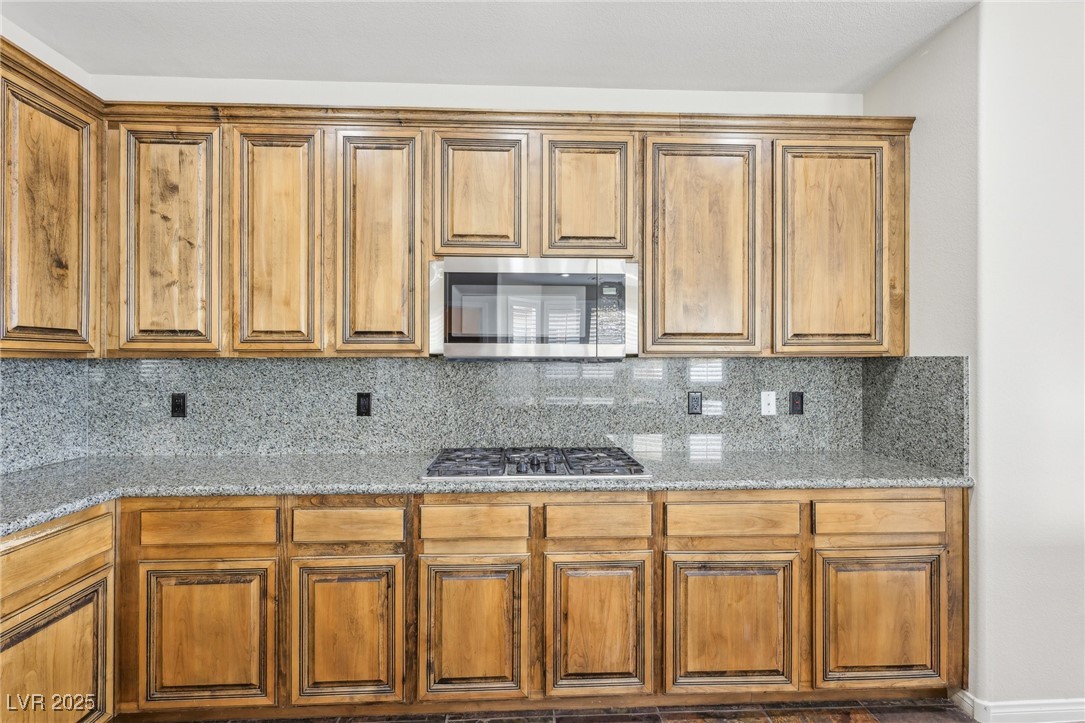 6188 Windfresh Drive Las Vegas, NV 89148 - Photo 27 of 94 Kitchen with decorative backsplash, light stone co