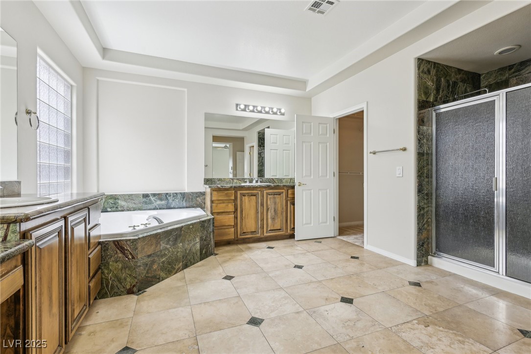 6188 Windfresh Drive Las Vegas, NV 89148 - Photo 56 of 94 Bathroom with a shower stall, a garden tub, two va