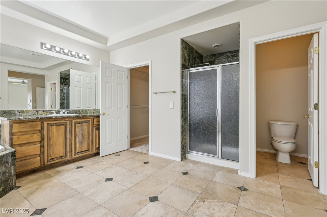 6188 Windfresh Drive Las Vegas, NV 89148 - Photo 57 of 94 Bathroom with vanity, a tray ceiling, a marble sta