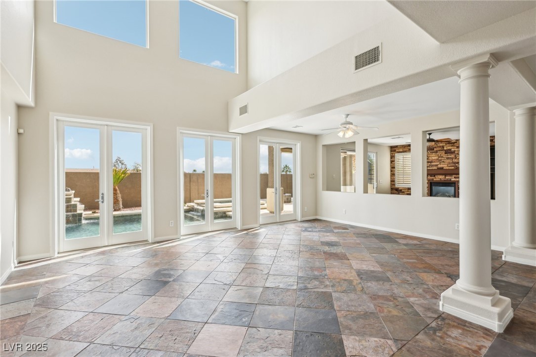 6188 Windfresh Drive Las Vegas, NV 89148 - Photo 7 of 94 Unfurnished living room with slate floors, french