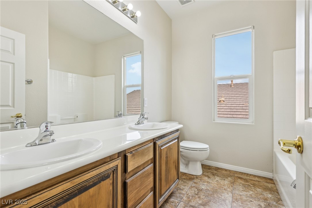 6188 Windfresh Drive Las Vegas, NV 89148 - Photo 79 of 94 Full bath with double vanity, toilet, baseboards,