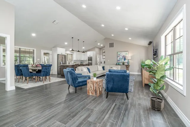 a living room with furniture and a wooden floor