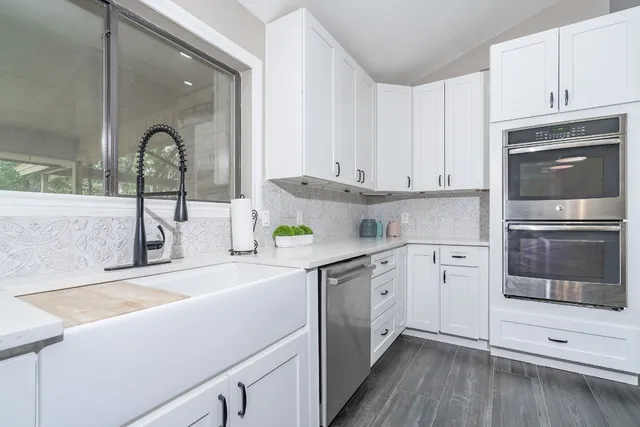 a kitchen with a sink cabinets and stainless steel appliances