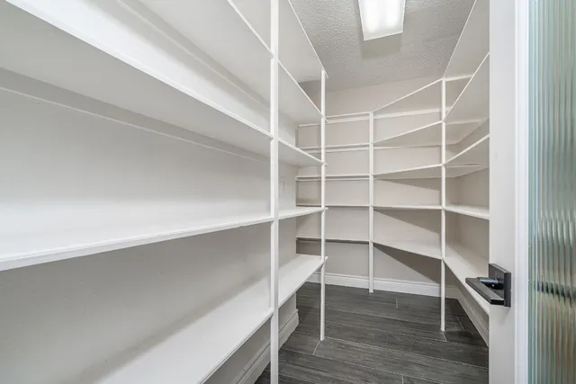 a view of walk in closet with empty racks