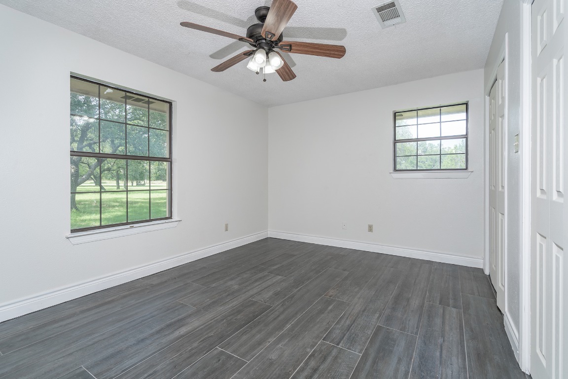 444 Logan Ranch Road Georgetown, TX 78628 - Photo 20 of 36 wooden floor in an empty room with a window