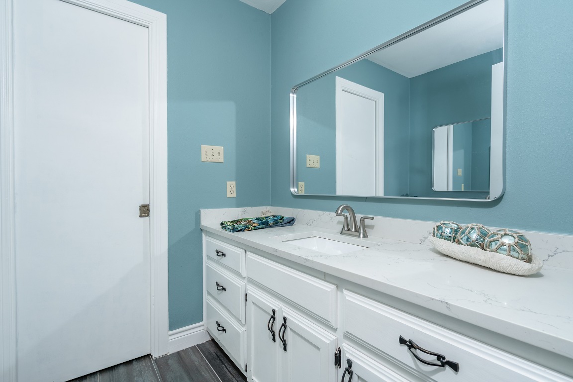 444 Logan Ranch Road Georgetown, TX 78628 - Photo 21 of 36 a bathroom with a sink and a mirror