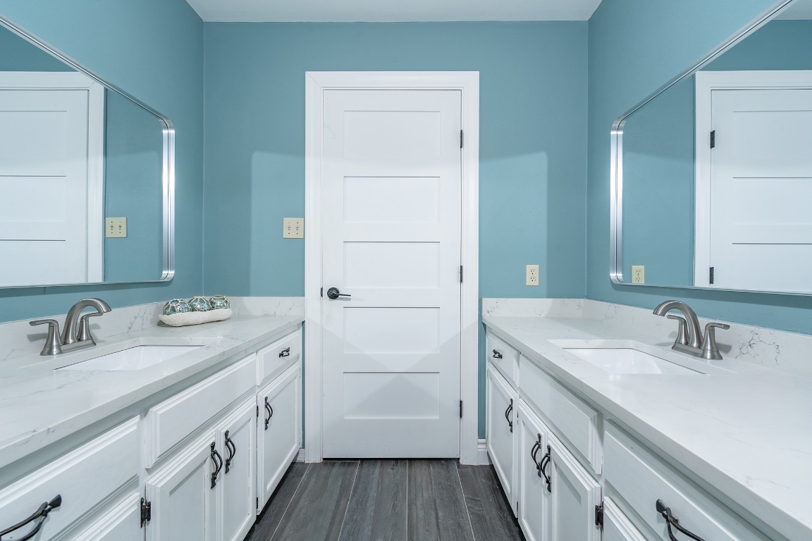 444 Logan Ranch Road Georgetown, TX 78628 - Photo 22 of 36 a bathroom with a sink a vanity and a mirror